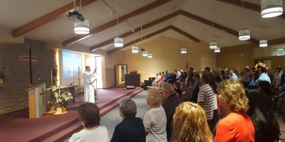 pastor preaching to a crowd in a church